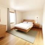 A bedroom with an accent color, featuring wooden floors and a soft blue rug under the bed. The room includes a white chest of drawers on one side, grey curtains at a large window on another wall, a modern black frame for the headboard, and a colorful painting above it. A small nightstand is placed near the bedside table. Bright LED lights hang from the ceiling. Rendered in Blender software, capturing the natural light coming through the windows. --ar 101:80 --style raw --profile drbewcy --dref https://s.mj.run/5q3zpLYt99E --stylize 350 --v 6.1 Job ID: 1da74172-d22d-4753-95db-6b5f19b148ce
